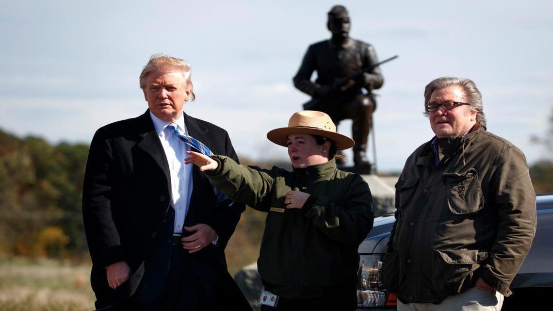 Interpretive park ranger Caitlin Kostic, center, gives a tour near the high-water mark of the Confederacy at Gettysburg National Military Park to Republican presidential candidate Donald Trump, left, and campaign CEO Steve Bannon, Saturday, Oct. 22, 2016, in Gettysburg, Pa.