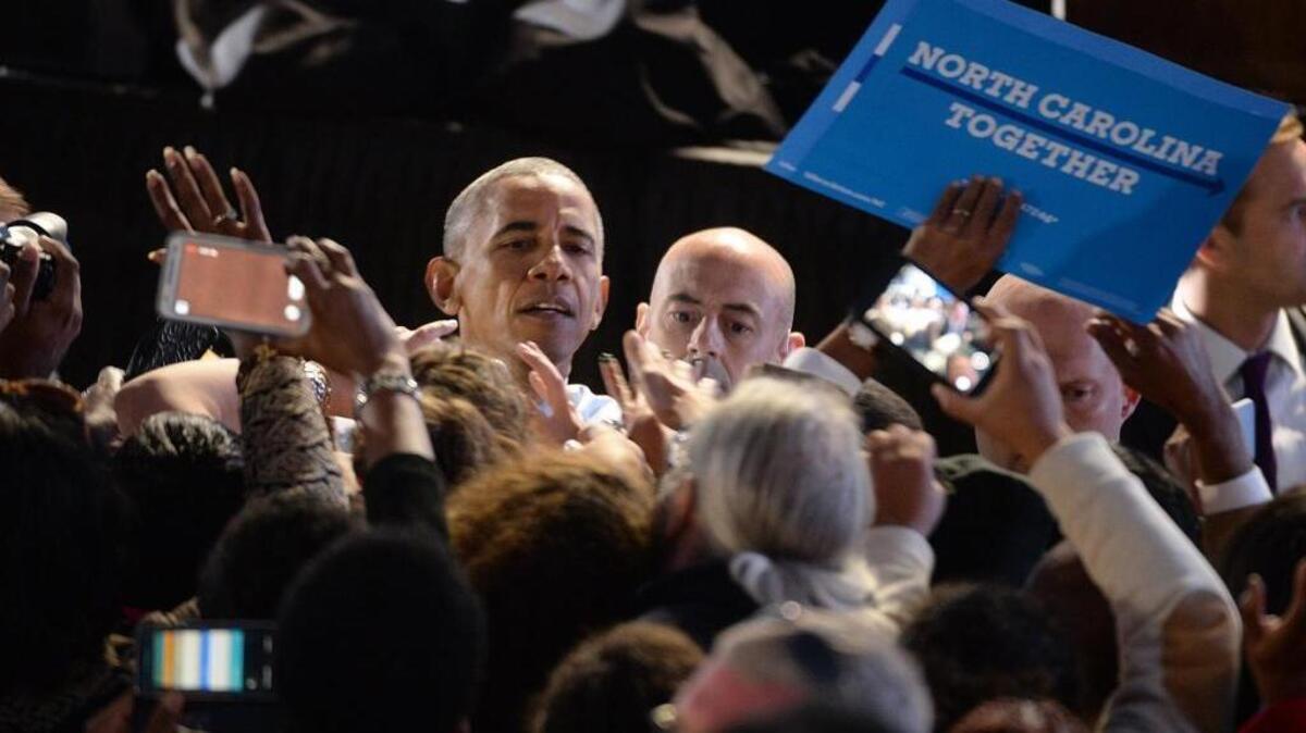 In Greensboro, North Carolina, President Barack Obama works the rope line after stumping for Democratic presidential nominee Hillary Clinton on Tuesday, Oct. 11, 2016. Recently, Obama recorded endorsements for two down-ballot Democrats to run in upcoming TV and radio ads. Obama is lending his support to U.S. Senate hopeful Deborah Ross and gubernatorial nominee Roy Cooper.