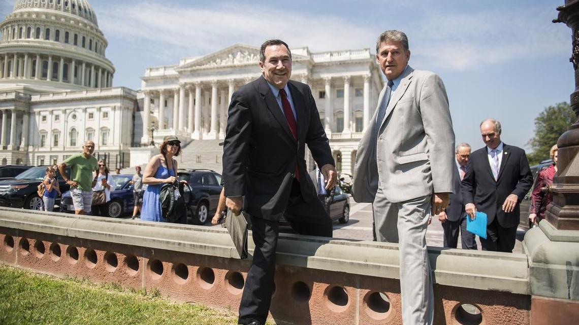 Sens. Joe Donnelly, D-Ind., left, and Joe Manchin, D-W.Va., arrive for news conference on the east lawn of the Capitol to unveil a new economic agenda titled "A Better Deal on Trade and Jobs" on August 2, 2017.