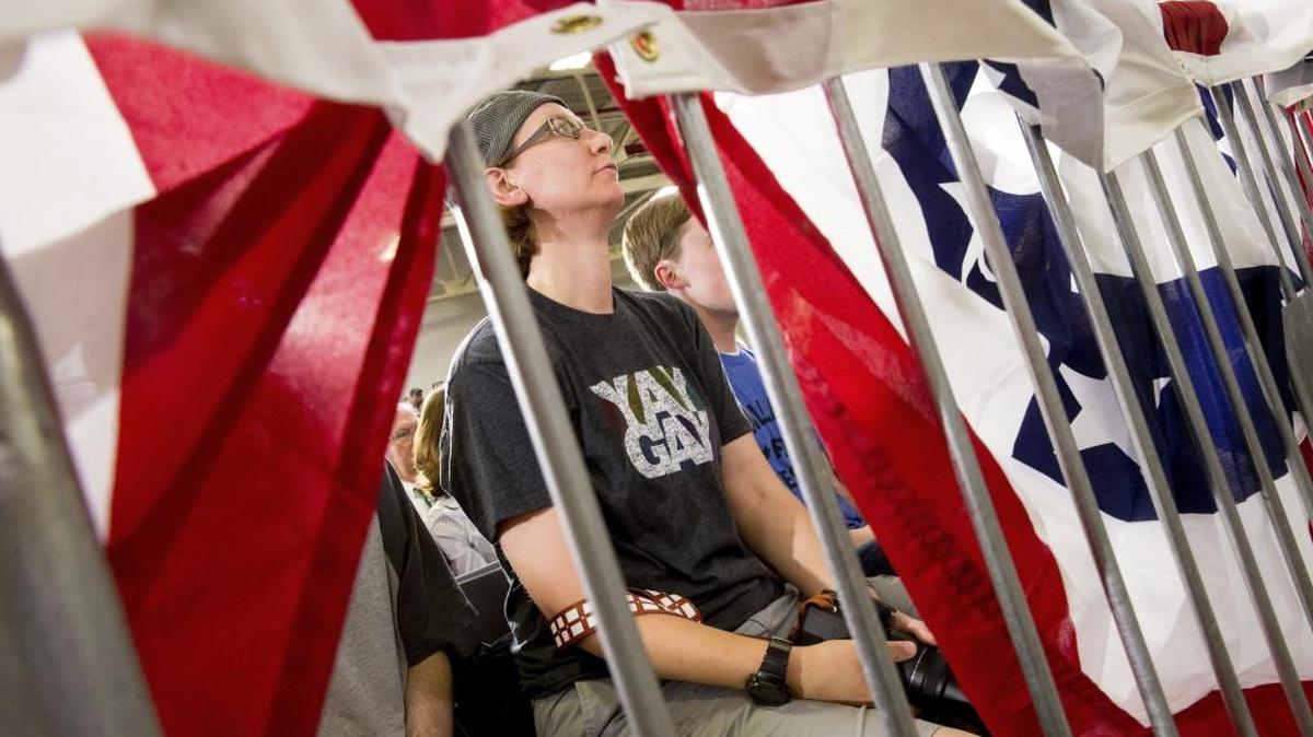 A member of the audience wears a shirt that reads "Yay Gay" as Democratic presidential candidate Hillary Clinton speaks at a rally at a warehouse for the company "Team Wendy," which produces helmets for military, law enforcement, and rescue teams, in Cleveland, Monday.