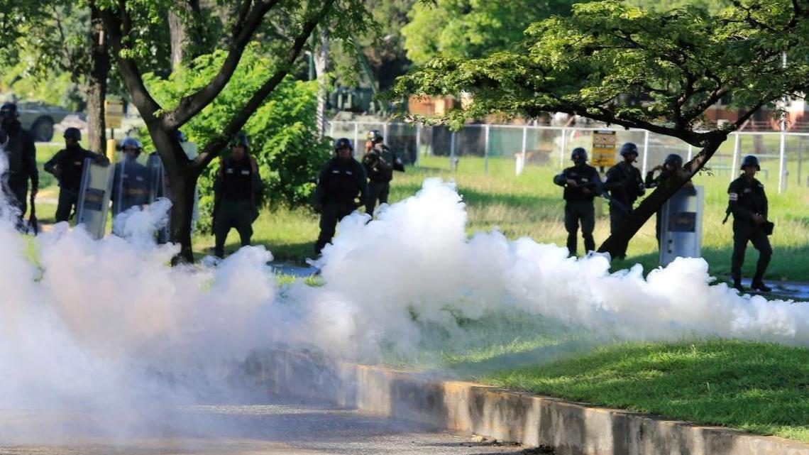 Venezuelan Bolivarian National Guard officers fire tear gas toward protesters in Valencia, Venezuela on Sunday Aug. 6, 2017. President Donald Trump raised the prospect of “military action” in Venezuela Friday, further heightening tensions in the oil-rich country.