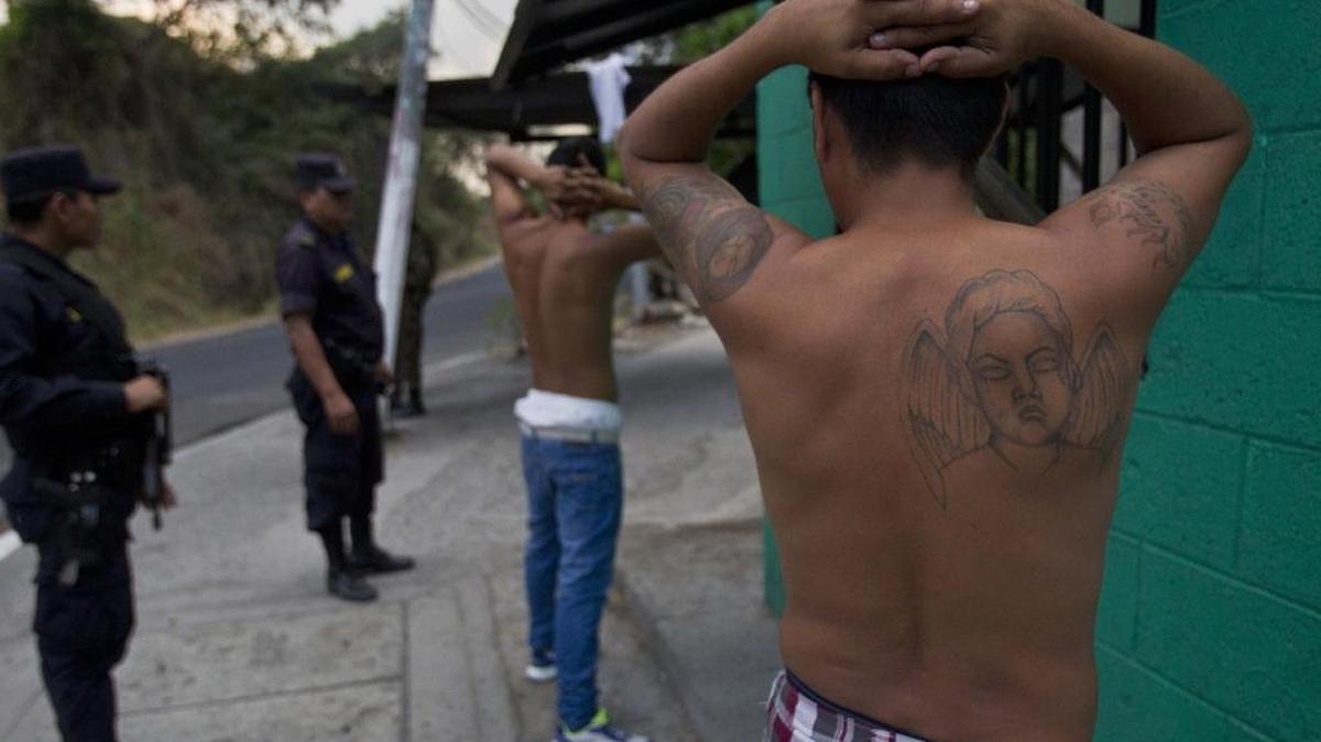 Salvadoran National Police detain two men during an anti-gang raid in San Salvador, El Salvador. DHS Secretary John Kelly told a seminar on Central American violence that Americans drug consumption is largely to blame for the flow of migrants from Honduras and El Salvador.