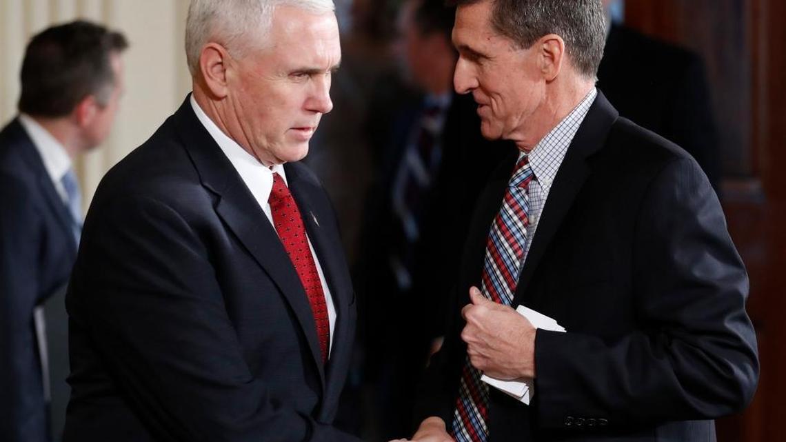 Former National Security Adviser Michael Flynn (right), who was fired in February for misleading Vice President Mike Pence and other officials about his conversations with the Russian ambassador to the U.S. In photo, Pence, left, and Flynn shake hands before the start of the President Donald Trump and Japanese Prime Minister Shinzo Abe joint news conference in the East Room of the White House, in Washington, Feb. 10, 2017.