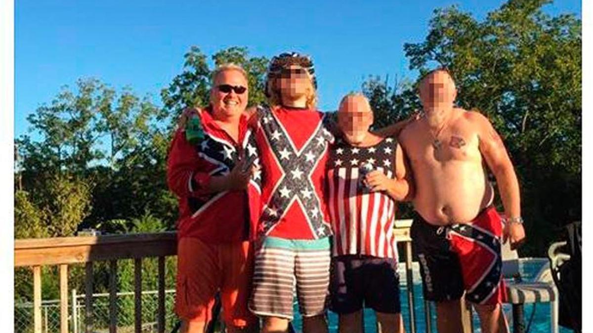 In this Facebook post, Dan Johnson, left, poses with friends wearing clothing with Confederate imagery.