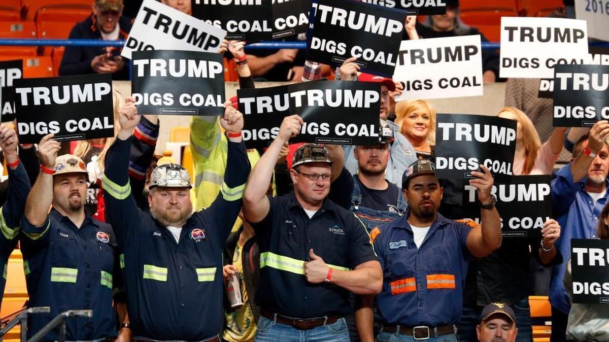 A group of coal miners waved signs for Republican presidential candidate Donald Trump as they waited for a rally in Charleston, W.Va., on Thursday, May 5, 2016. GOP foreign policy experts were not so supportive.