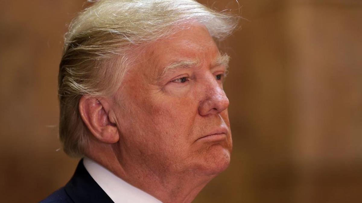 Republican presidential candidate Donald Trump listens to introductory remarks before speaking in New York's Trump Tower building on Monday. At a later event Monday evening, Trump was about to deliver prepared remarks lauding New York values when he mistakenly mentioned the name of a popular convenience store chain in place of 9/11.