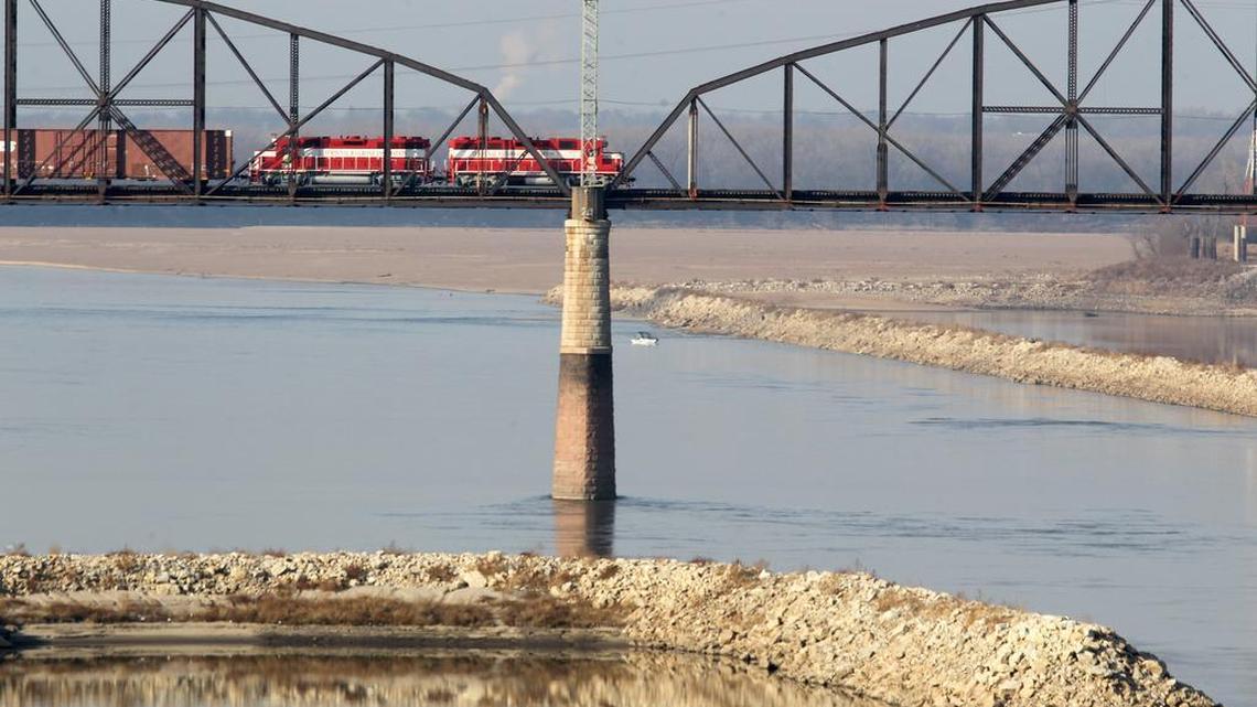 The Merchants railroad bridge over the Mississippi River at St. Louis was built in 1890, and its truss spans need to be replaced. Only one train at a time can cross the two-track bridge, and they creep across it at 5 mph.