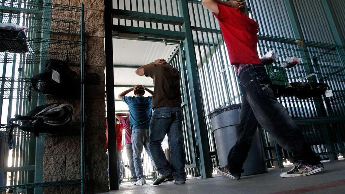 Undocumented immigrants prepare to enter a bus after being processed at Tucson Sector U.S. Border Patrol Headquarters Thursday, Aug. 9, 2012, in Tucson, Ariz.