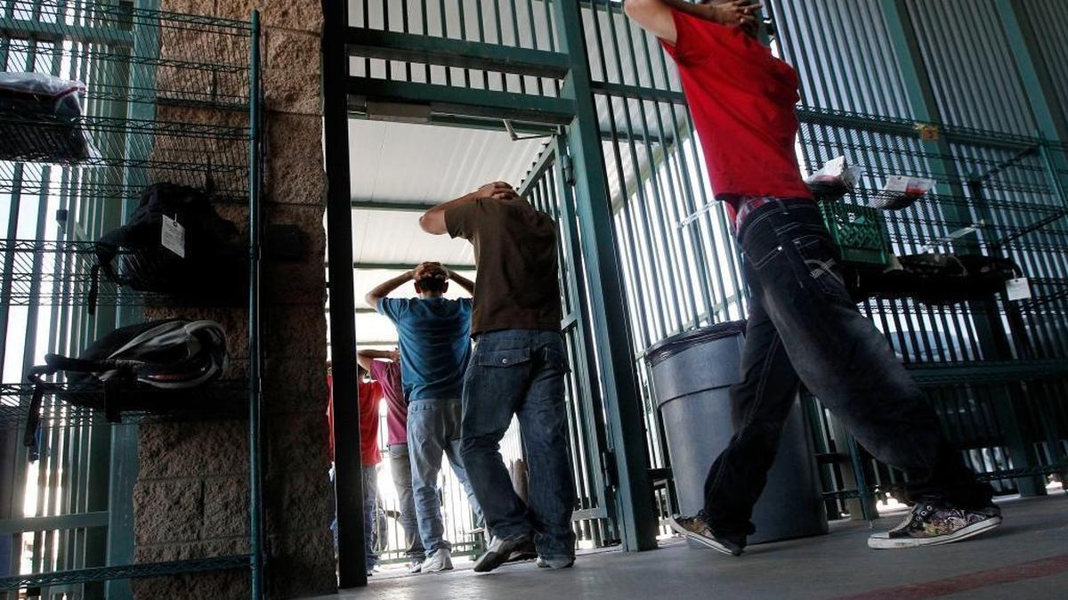 Undocumented immigrants prepare to enter a bus after being processed at Tucson Sector U.S. Border Patrol Headquarters Thursday, Aug. 9, 2012, in Tucson, Ariz.