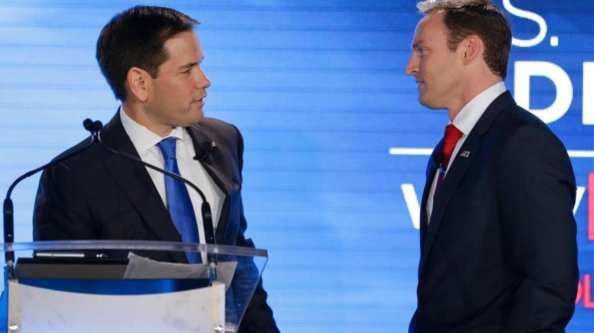 Republican Sen. Marco Rubio, left, and Democratic Rep. Patrick Murphy talk during a commercial break in their debate at the University of Central Florida, Monday, Oct. 17, 2016, in Orlando.
