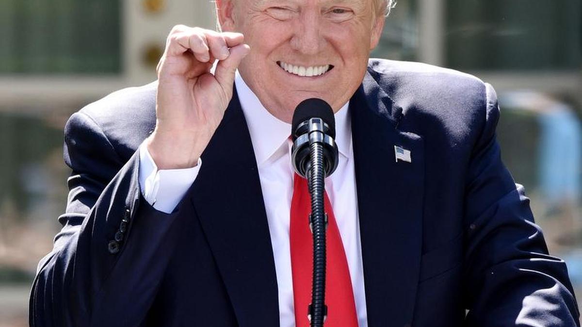 President Donald Trump gestures to indicate his belief that the Paris climate change accord would do very little to ease global warming.
