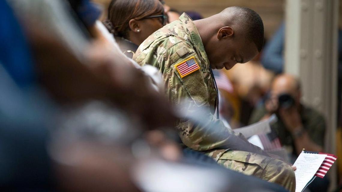 U.S. Army Specialist Shane Cardel, of Jamaica, bows his head after taking the Naturalization Oath of Allegiance to the United States of America Friday, June 30, 2017, during a naturalization ceremony at the New York Public Library in New York. Over 190 immigrants from 59 countries became American citizens at the fourth annual Independence Day naturalization ceremony hosted by the library.