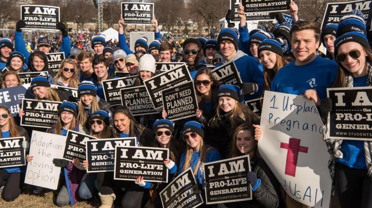 A group from Charlotte Christian School in Charlotte, N.C., poses for a photo on the National Mall along with thousands of anti-abortion demonstrators who were about to march to the Supreme Court during the March for Life in Washington on Friday, Jan. 27, 2017.