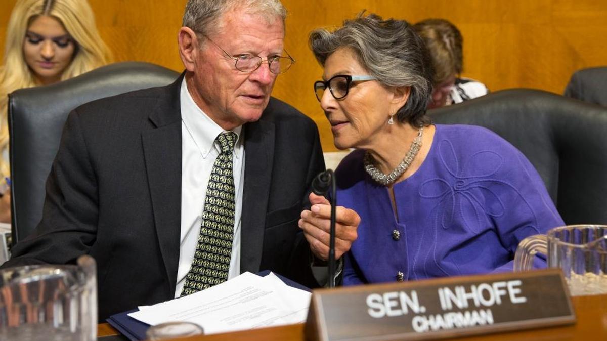 FILE - In this Sept. 16, 2015, file photo, Senate Environment and Public Works Committee Chairman Sen. Jim Inhofe, R-Okla., talks with the committee's ranking member Sen. Barbara Boxer, D-Calif. on Capitol Hill in Washington. Working closely together, and frequently gushing about the other, the two have succeeded where few have.