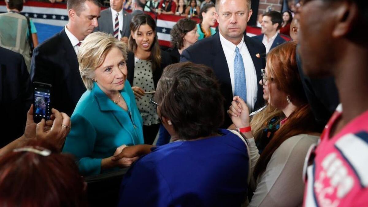 In this Thursday, Aug. 25, 2016, file photo, Democratic presidential candidate Hillary Clinton greets people in the audience after speaking at a campaign event at Truckee Meadows Community College in Reno, Nev. Donald Trump is doing relatively well in Nevada, due to the state of its economy, its large population of non-college graduates and history of ticket-splitting.
