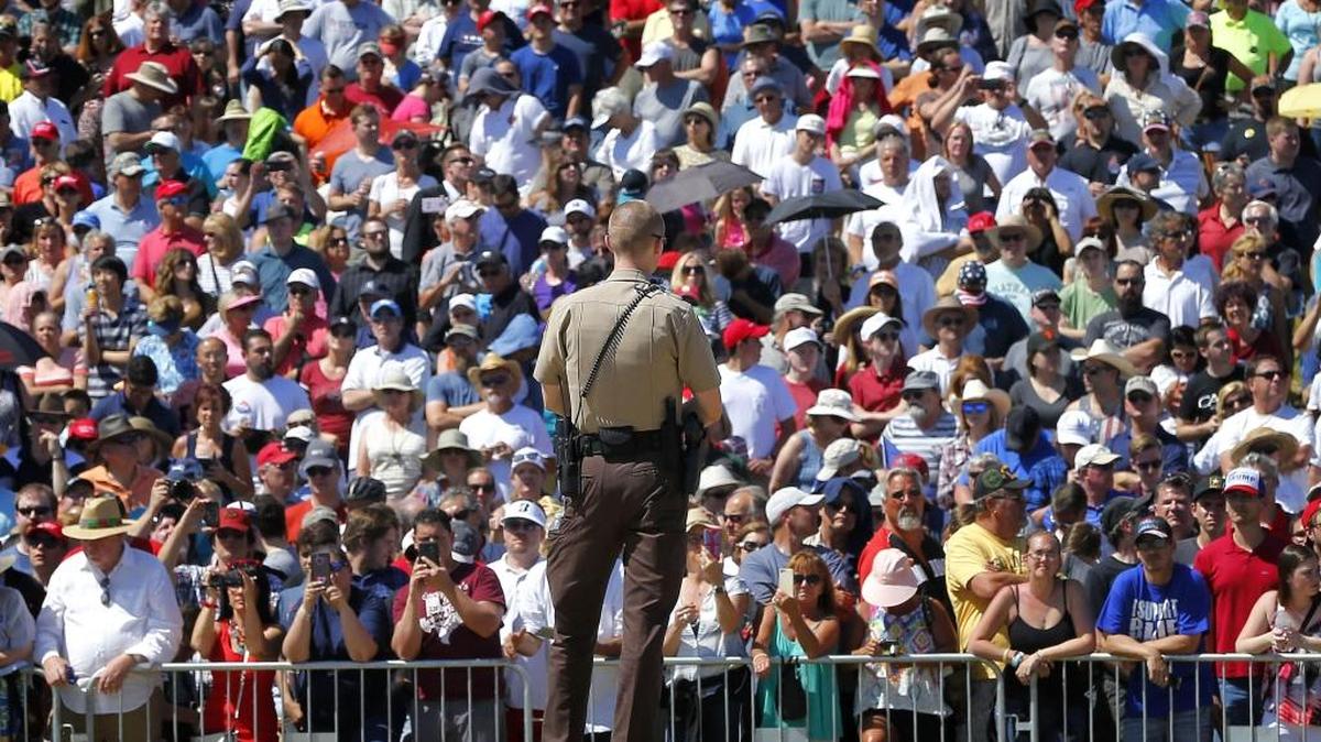 A Maricopa County sheriff’s deputy watches the crowd as Republican presidential candidate Donald Trump speaks during a campaign rally, Saturday, March 19, 2016. With growing concerns about terrorism and unruly crowds, security is expected to be especially tight at the Republican National Convention in Cleveland in July.