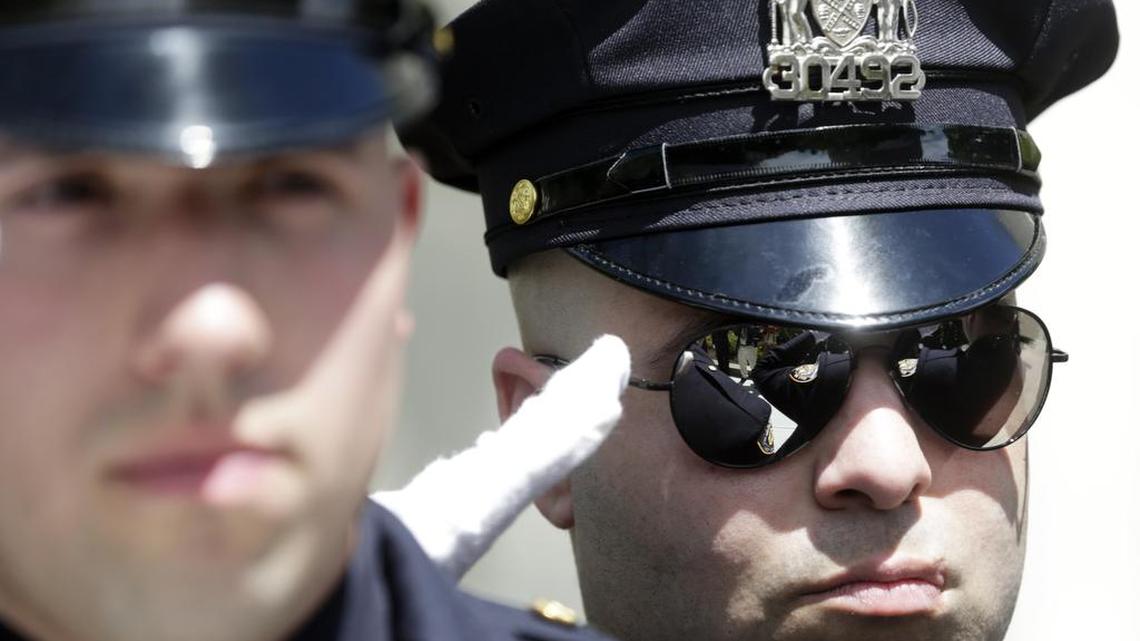 A New York City police officer salutes during a ceremony at the New York State Police Officers' Memorial on Tuesday, May 10, 2016, in Albany, N.Y. A new “Blue Lives Matter” push seeks to raise penalties for violence against police and first responders and may also serve as a controversial counter to the Black Lives Matter movement.