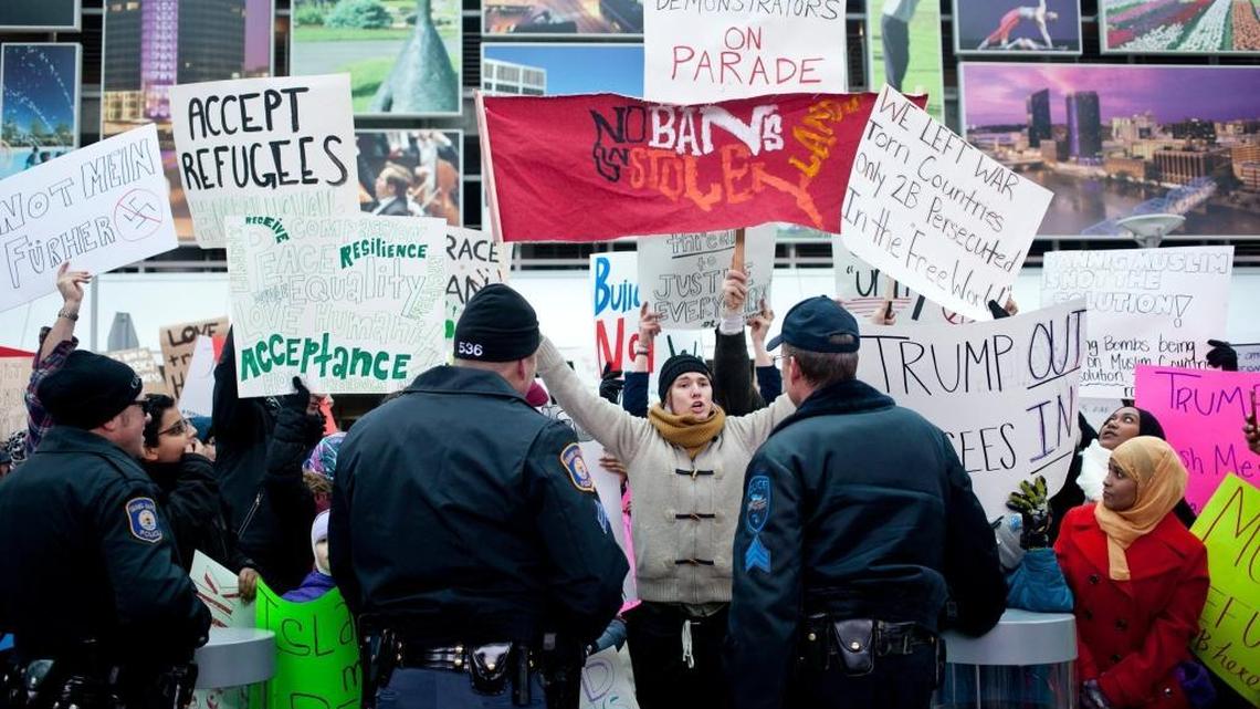 Police confronted protesters at the Gerald R. Ford International Airport in Grand Rapids, Mich., on Sunday, Feb. 5, 2017. Hundreds of people took part in protests of President Donald Trump's attempt to ban refugees and travelers from seven predominantly Muslim countries from entering the country.