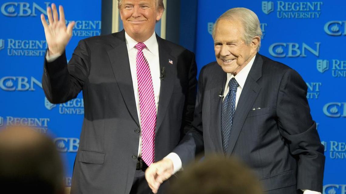 Republican presidential candidate, Donald Trump, accompanied by the Rev. Pat Robertson, waves as he arrives for an appearance at Regent University in Virginia Beach, Va., on Wednesday, Feb. 24, 2016.