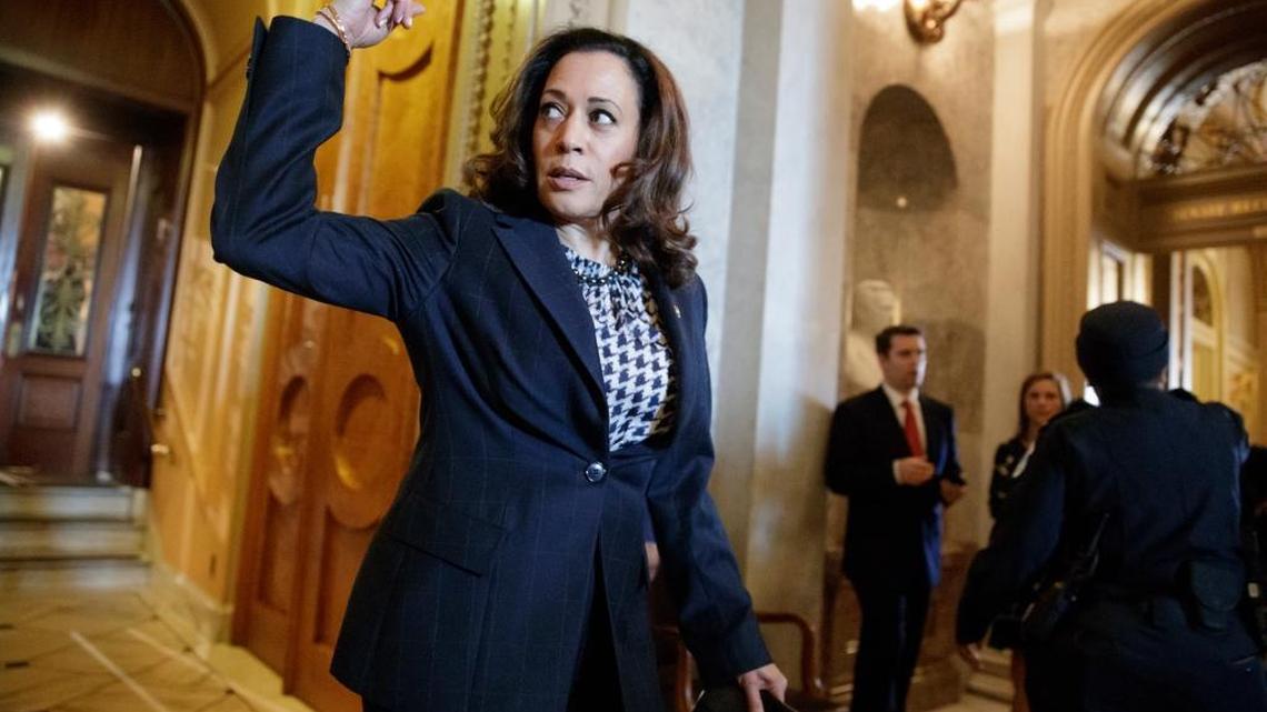Sen. Kamala Harris, D-Calif. signals to an aide as she steps out of the Senate Chamber on Capitol Hill in Washington, Wednesday, March 1, 2017, during the vote to confirm Interior Secretary-designate Ryan Zinke.