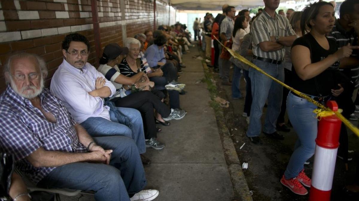 People line up outside a school set up as a validation center to certify the authenticity of their signatures in Caracas, Venezuela, Monday, June 20, 2016. Venezuela starts a crucial stage in the possible recall referendum against President Nicolas Maduro with the validation of 1.3 million signatures supporting the referendum. The U.S. House Foreign Affairs Committee held a hearing on Venezuela’s future on Wednesday, June 22, 2016.