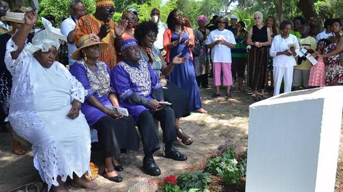 In this file photo, from left to right, Nana Yaa Asantewa, Cleo Stokes, Scott Gibbs and Sharon Joyce-Millen, project manager for the 27th Annual Gullah Festival, sing with those gathered for the ceremony on Aug. 5, 2013.