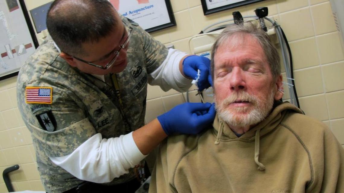 A doctor performs acupuncture on a paralyzed patient at the Milwaukee VA Medical Center. Veterans eligible for VA treatment would lose federal tax credits under a House-passed repeal of Obamacare – even if they choose not to accept VA care.