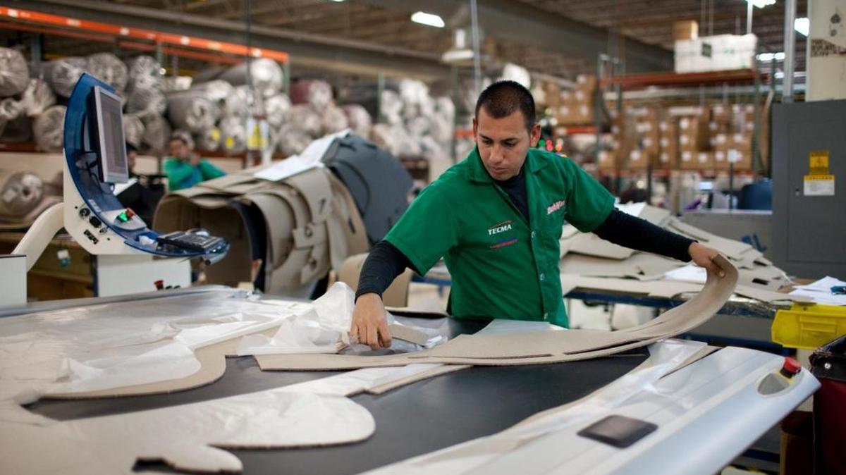 Marcos Godoy of Mexico City manufactures car dash mats at a maquiladora belonging to the TECMA group in Ciudad Juarez, Mexico, on Dec. 27, 2013. Donald Trump and Hillary Clinton both want to make changes to trade agreements to bring jobs back to the United States, but experts say those changes could put additional pressure on North Carolina industries that have already suffered from recent international commerce pacts.