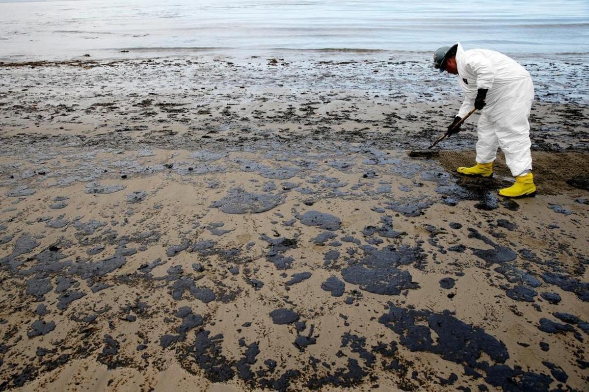 A worker removes oil from the sand at Refugio State Beach on May 21, 2015, one month after a broken pipelines caused an oil spill north of Santa Barbara, Calif. The broken pipeline was part of a network of pipes that brings offshore oil to land on its way to refineries. The Trump administration on Thursday, Jan. 4, 2018 moved to vastly expand offshore drilling nationwide in federal waters, including those off the California coast.