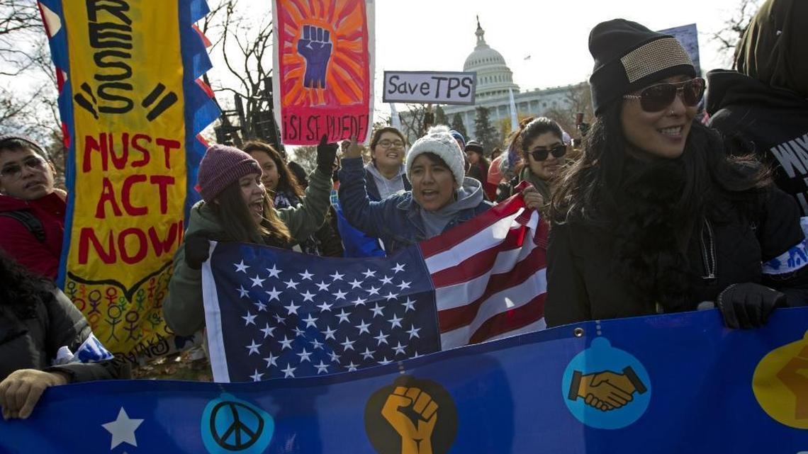 Demonstrators march during an immigration rally in support of the Temporary Protected Status (TPS) and Deferred Action for Childhood Arrivals (DACA), programs on Capitol Hill in Washington, Wednesday, Dec. 6, 2017.