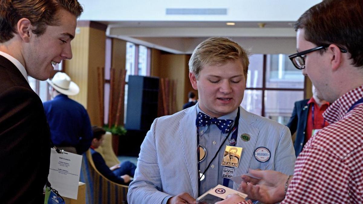 Jack Bell, left, and Jack Pickett, center, both 18-year-old Republicans from Washington state, network at a Youth Caucus event held as part of the Republican National Convention in Cleveland, Ohio, on July 19, 2016.