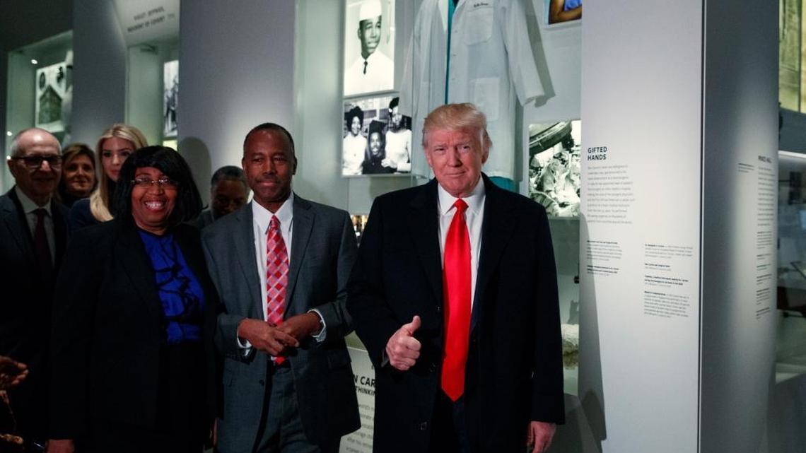 President Donald Trump gives a thumbs up during a tour of the National Museum of African American History and Culture with Housing and Urban Development Secretary-designate Dr. Ben Carson and his wife Candy Carson, Tuesday, Feb. 21, 2017, in Washington.
