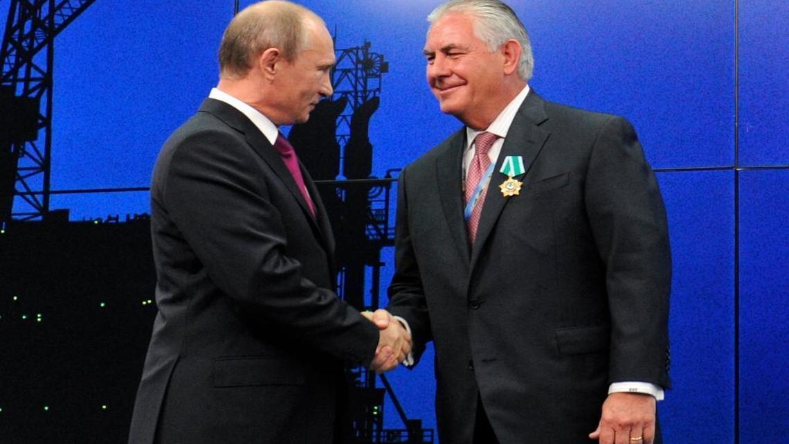 ExxonMobil CEO Rex Tillerson and now President-elect Donald Trump nominee as Secretary of State will be questioned over his ties to Russia. In this photo taken Thursday, June 21, 2012, Russian President Vladimir Putin presents Tillerson with a Russian medal at an award ceremony of heads and employees of energy companies at the St. Petersburg economic forum in St. Petersburg, Russia.