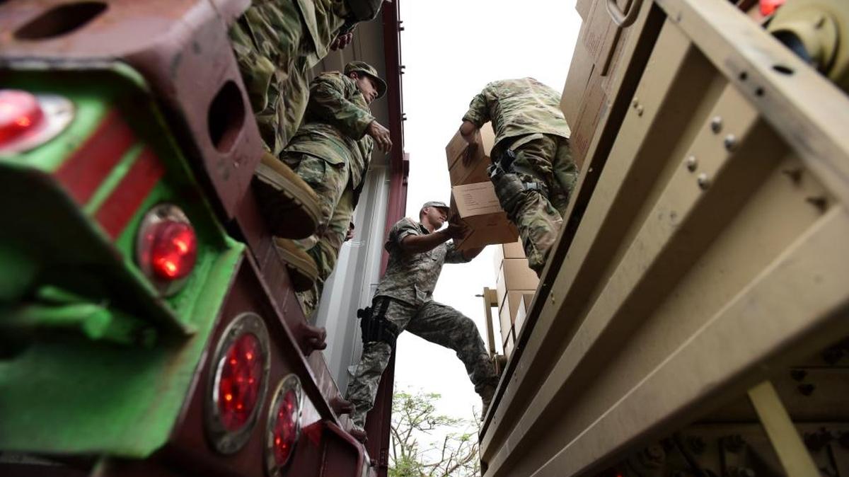 Soldiers and National Guard organize aid for the Santa Ana community in the aftermath of Hurricane Maria in Guayama, Puerto Rico, Thursday.