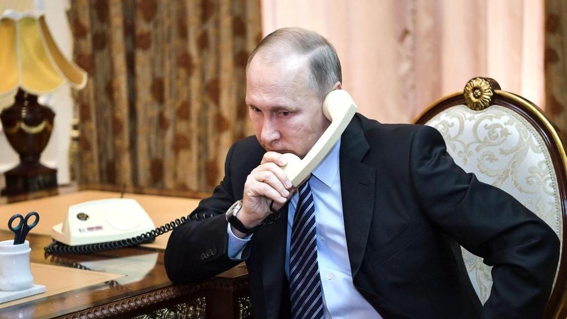 Russian President Vladimir Putin talks to Turkmens President Gurbanguly Berdimuhamedov by phone during a breakfast with Tajik President Emomali Rakhmon in Dushanbe, Tajikistan, Feb. 28, 2017.