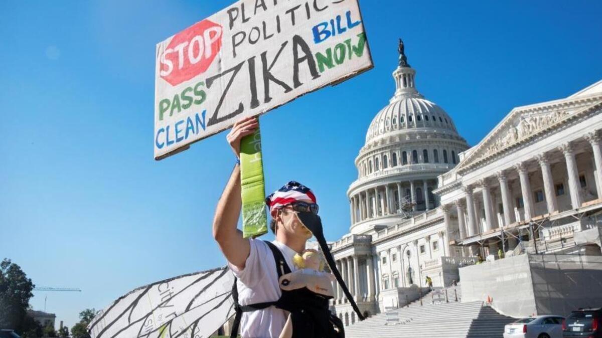 A demonstrator outside the U.S. Capitol on Sept. 14, 2016, protests the lack of congressional action on Zika funding.