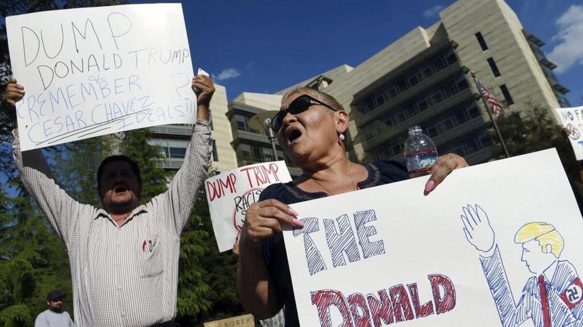 Jenny Ramirez, right, shouts out to passing motorists as she joined a group of about 50 people from about four different groups, calling for voters to vote for someone other than Donald Trump in downtown Fresno, Calif., on March 31, 2016.