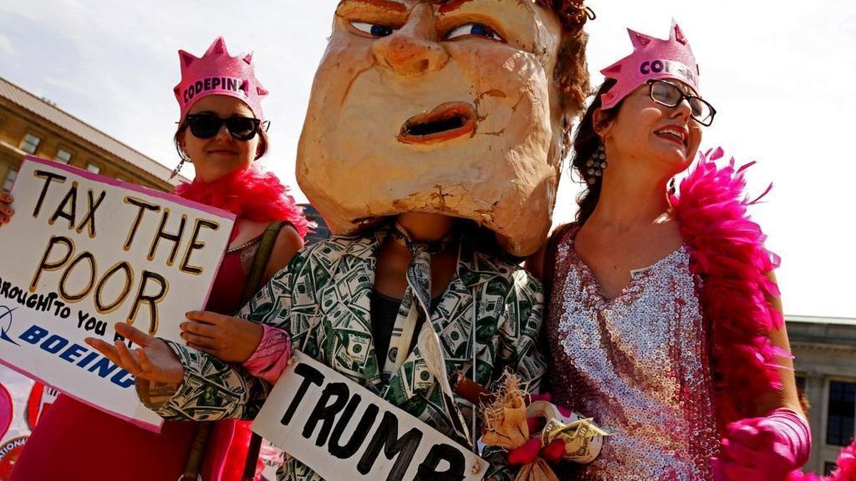 Protesters from Code Pink make fun of Trump as they rally in downtown Cleveland on Monday, July 18, 2016.