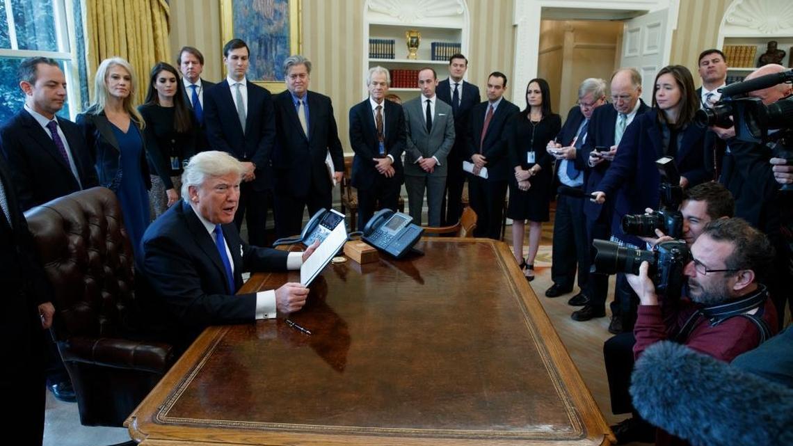 President Donald Trump talks with reporters in the Oval Office of the White House, Tuesday, Jan. 24, 2017, before signing an executive order on the Dakota Access pipeline.