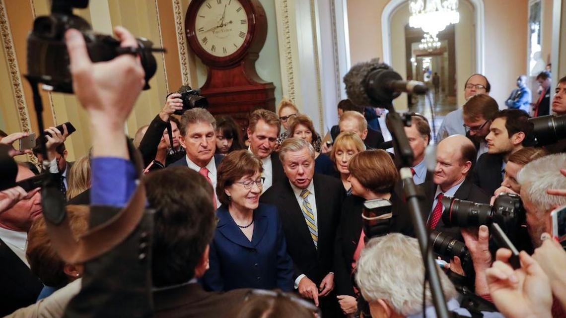 Sen. Lindsey Graham, R-S.C., center, speaks to members of the media outside the Senate Chamber on Capitol Hill in Washington Monday after reaching an agreement to advance a bill ending the government shutdown. With Graham are from left, Sen. Joe Manchin, D-W.Va., Sen. Susan Collins, R-Maine, Sen. Jeff Flake, R-Ariz., Sen. Lisa Murkowski, R-Alaska, Sen. Maggie Hassan, D-N.H., and Sen. Chris Coons, D-Del.