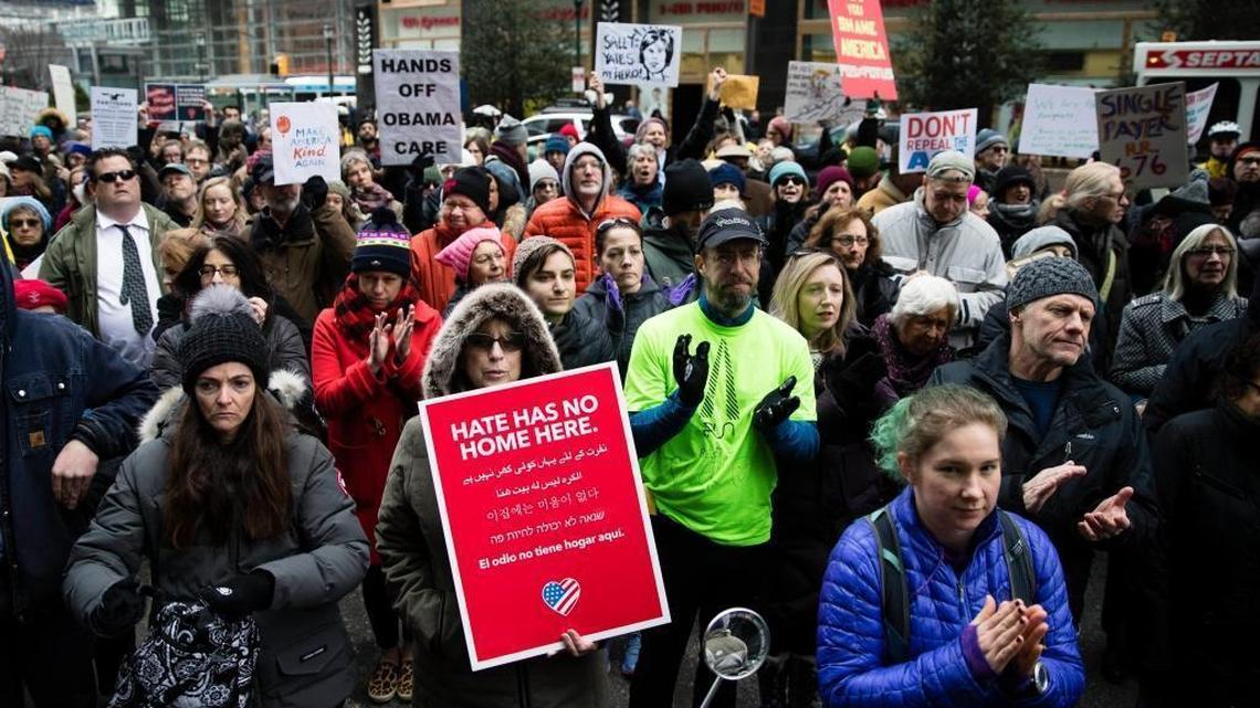 Protesters gather outside an office of Sen. Pat Toomey, R-Pa., calling on him to oppose repealing the Affordable Care Act without offering a replacement, in Philadelphia, Tuesday, Jan. 31, 2017.