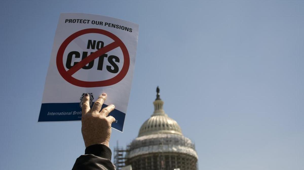 One of the signs brandished at Thursday rally to protest proposed pension cuts.