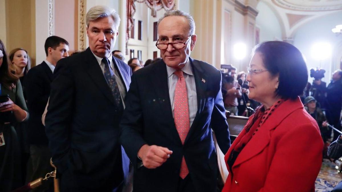 Senate Minority Leader Chuck Schumer, D-N.Y., flanked by Sen. Sheldon Whitehouse, D-R.I., left, and Sen. Mazie Hirono, D-Hawaii.
