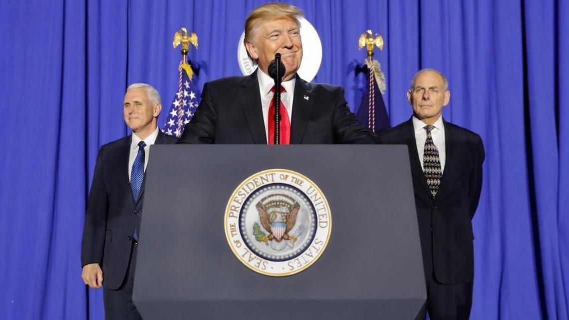 President Donald Trump, accompanied by Vice President Mike Pence, left, and Homeland Security Secretary John F. Kelly, pauses while speaking at the Homeland Security Department in Washington, Wednesday, Jan. 25, 2017.