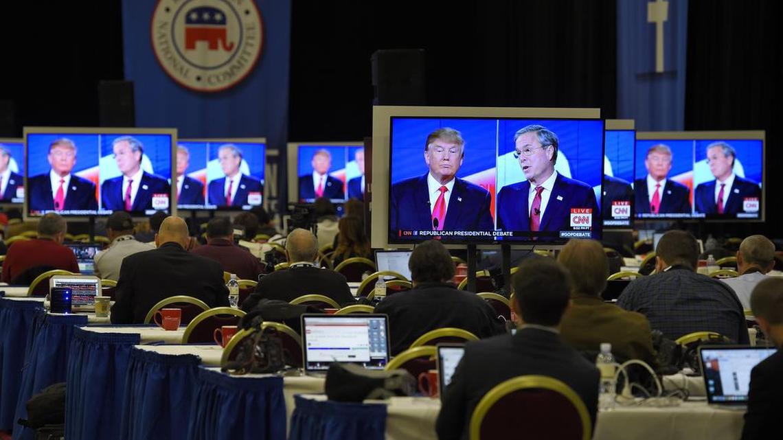 Donald Trump, left, and Jeb Bush are seen on television monitors in the media workroom during the CNN Republican presidential debate at the Venetian Hotel & Casino on Tuesday, Dec. 15, 2015, in Las Vegas.