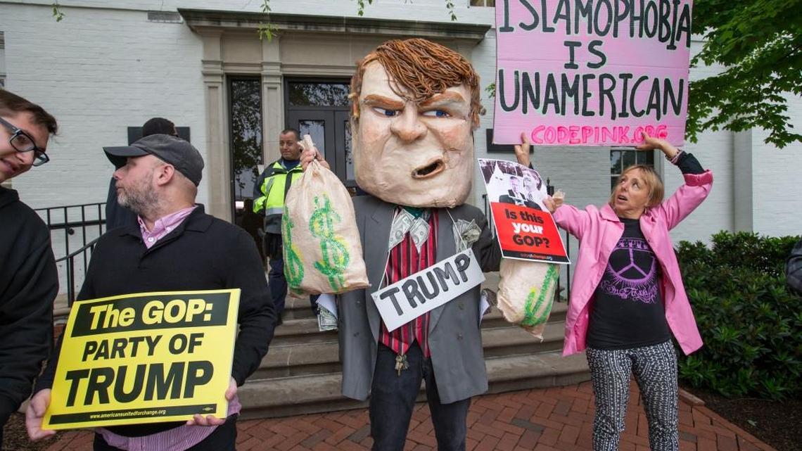 Demonstrators, including CodePink co-founder Medea Benjamin, right, protest against presumptive presidential nominee Donald Trump at the entrance of the Republican National Committee Headquarters on Capitol Hill in Washington, May 12, 2016, as Donald Trump meets with House Speaker Paul Ryan of Wisconsin.