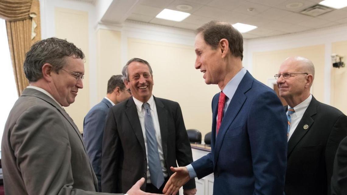 A bipartisan group of House and Senate lawmakers, from left, Rep. Thomas Massie, R-Ky., Rep. Mark Sanford, R-S.C., Sen. Ron Wyden, D-Ore., and Rep. Ted Poe, R-Texas, finish a news conference where they were united in their insistence on reforms to the FISA Amendments Reauthorization Act of 2017 to protect Americans' rights, at the Capitol in Washington, Wednesday, Jan. 10, 2018.
