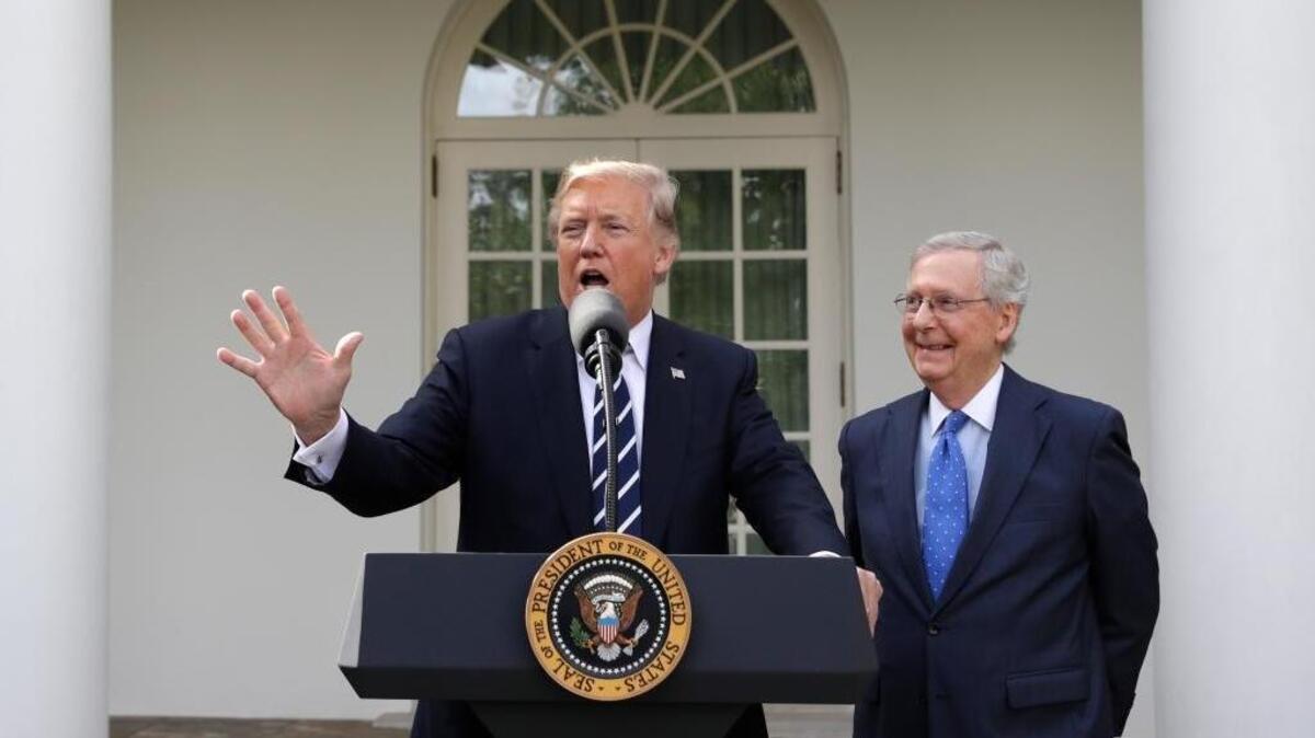 President Donald Trump answers questions with Senate Majority Leader Mitch McConnell, R-Ky., in the Rose Garden after their meeting at the White House, Monday, Oct. 16, 2017, in Washington.