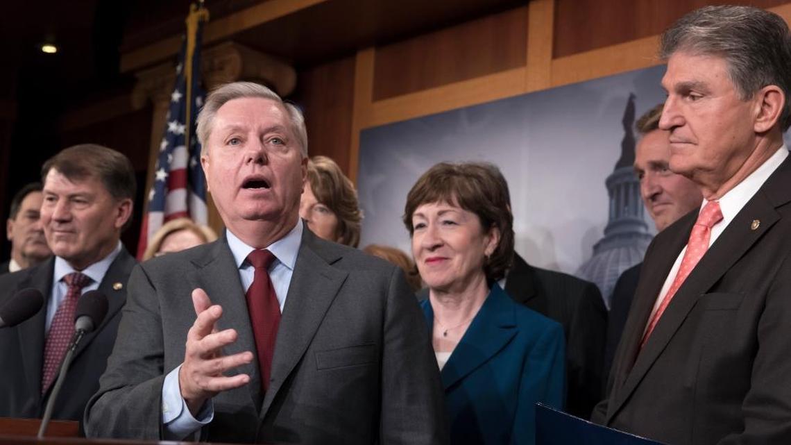 Sen. Lindsey Graham, R-S.C., joined by, from left, Sen. Mike Rounds, R-S.D., Sen. Susan Collins, R-Maine, and Sen. Joe Manchin, D-W.Va., talks Thursday about the immigration deal the senators crafted.