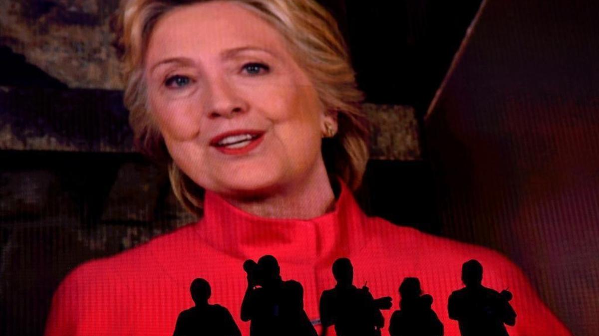 The silhouettes of photographers are seen as Hillary Clinton, 2016 Democratic presidential nominee, speaks on screen during the Democratic National Convention (DNC) in Philadelphia on Tuesday, July 26, 2016.